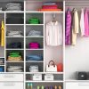 A wardrobe filled with clothes and shoes, showcasing how to organize wardrobe.