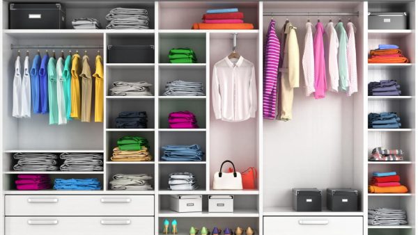 A wardrobe filled with clothes and shoes, showcasing how to organize wardrobe.