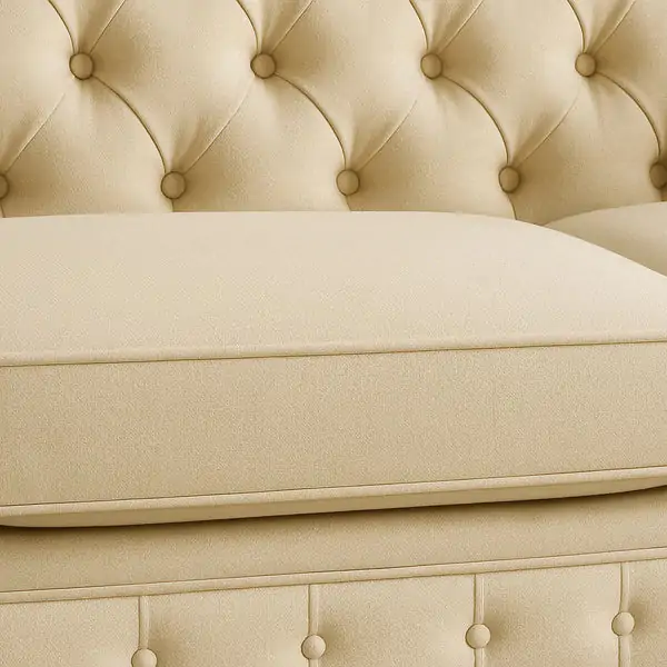 “Luxury Chesterfield sofa detail with cream upholstery and deep tufting”