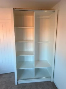 Climax Furniture Oslo Sliding Mirror Wardrobe 120cm white interior shelving during installation