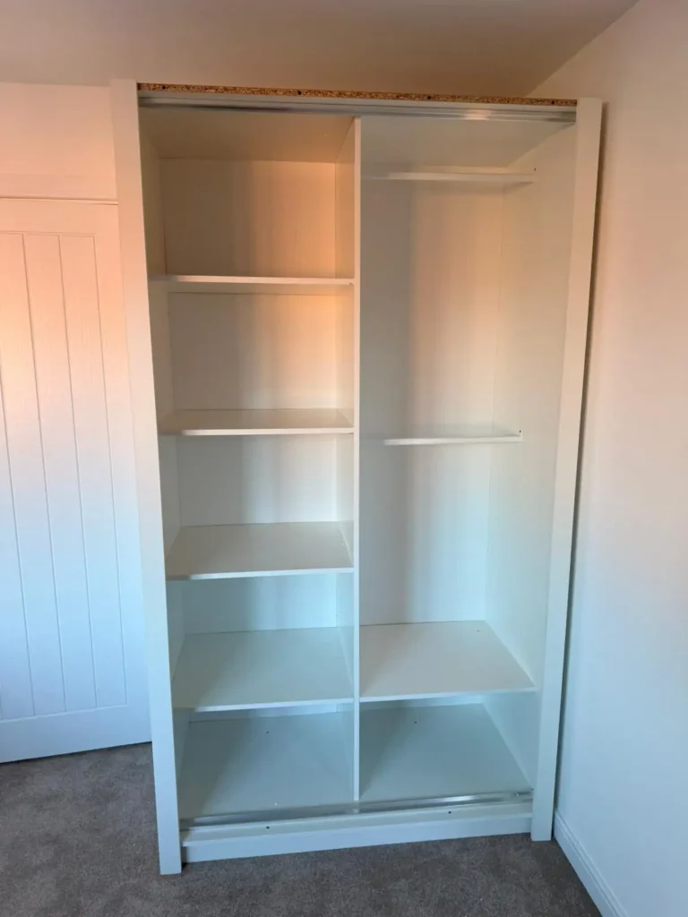 Climax Furniture Oslo Sliding Mirror Wardrobe 120cm white interior shelving during installation