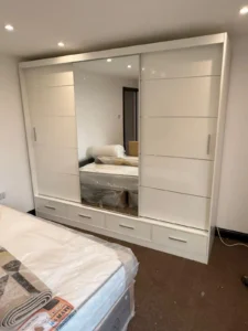 Climax Furniture Oslo Sliding Mirror Wardrobe 256cm white with drawers, installed in customer's bedroom
