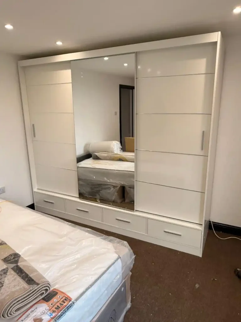 Climax Furniture Oslo Sliding Mirror Wardrobe 256cm white with drawers, installed in customer's bedroom