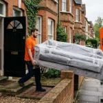 Climax Furniture buying guide – delivery team carrying a sofa into a UK home